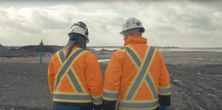 Image of EllisDon 2 employees from behind in the field.